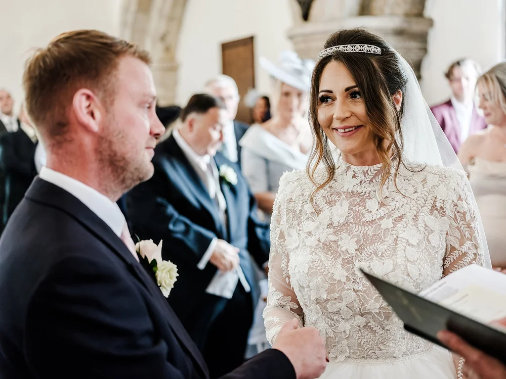 Guy and Jade exchanging vows in the chapel at Farnham Castle