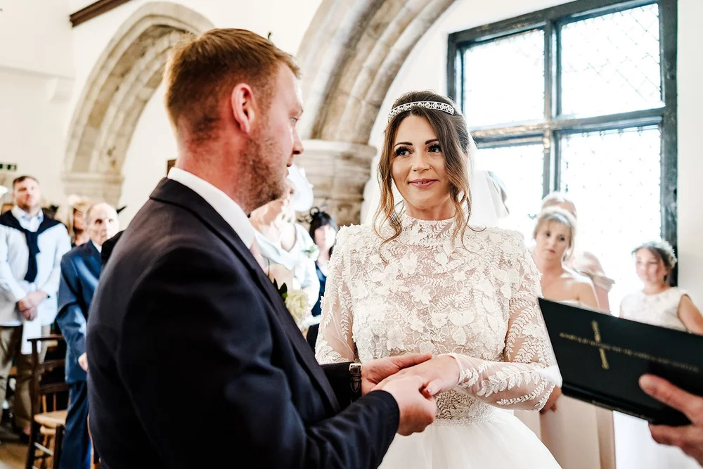 Guy reading his vows to Jade in the Norman chapel at Farnham Castle