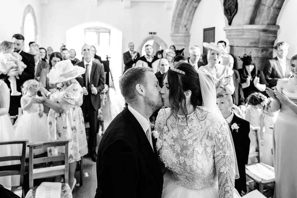 Guests watching the ceremony from the pews in the chapel at Farnham Castle
