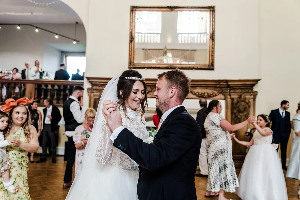 Jade and Guy dancing with guests around them at Farnham Castle