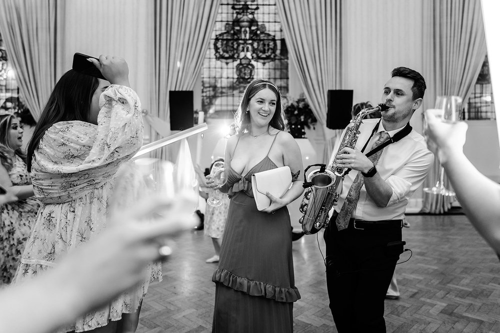 Guests watching the magician during the drinks reception at Farnham Castle