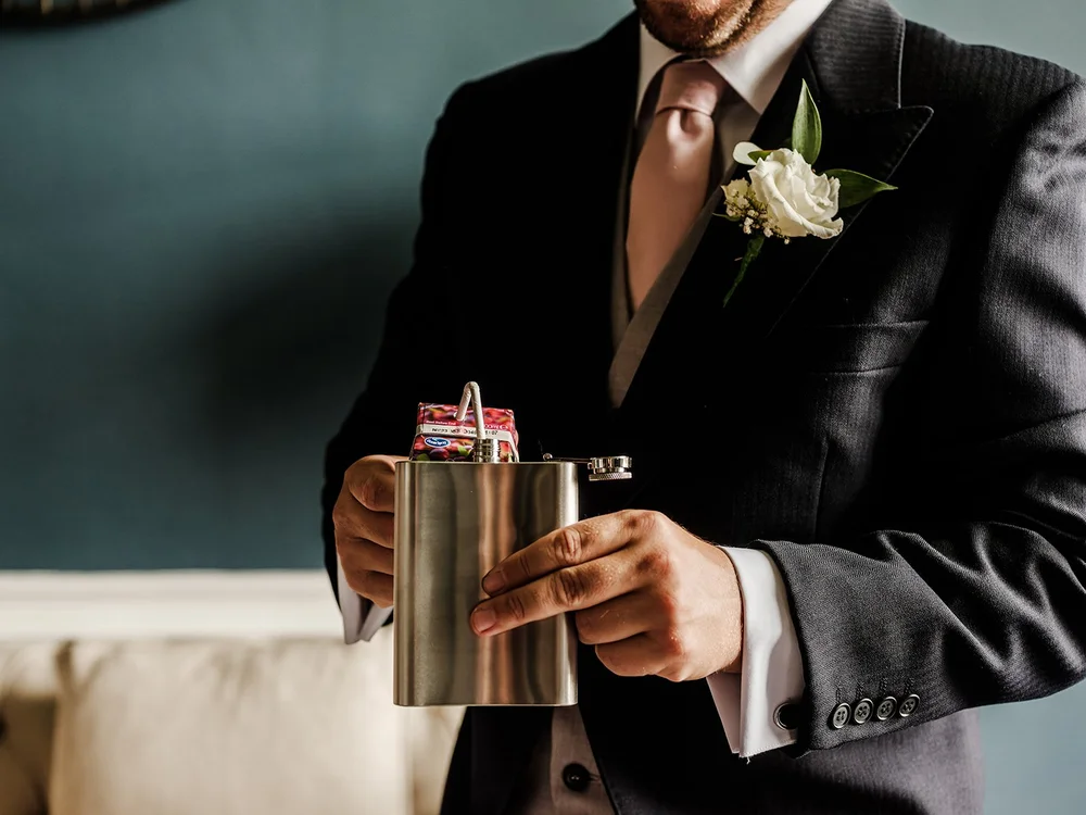 A detail of Guy&rsquo;s buttonhole and gift before the wedding