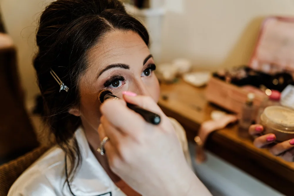 Jade having her make-up done on the morning of her Farnham Castle wedding