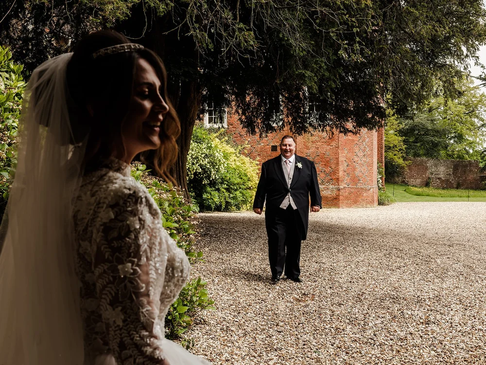 Jade waiting with her father on the gravel path at Farnham Castle