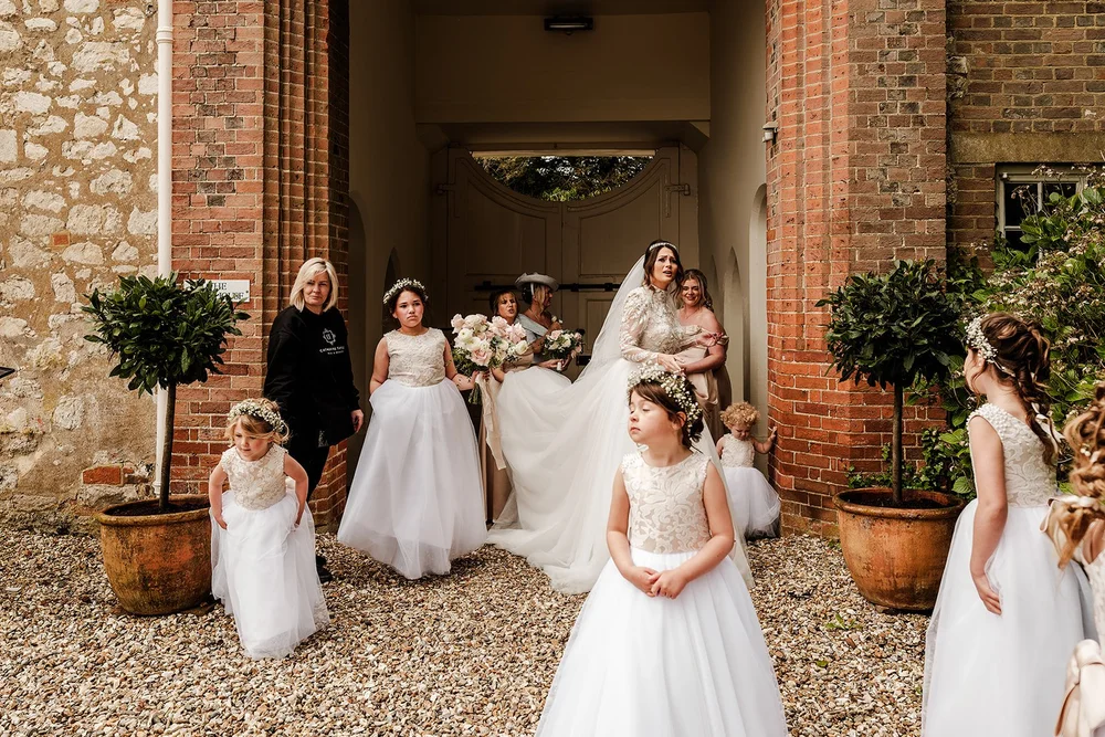 Jade with her bridesmaids in the courtyard at Farnham Castle