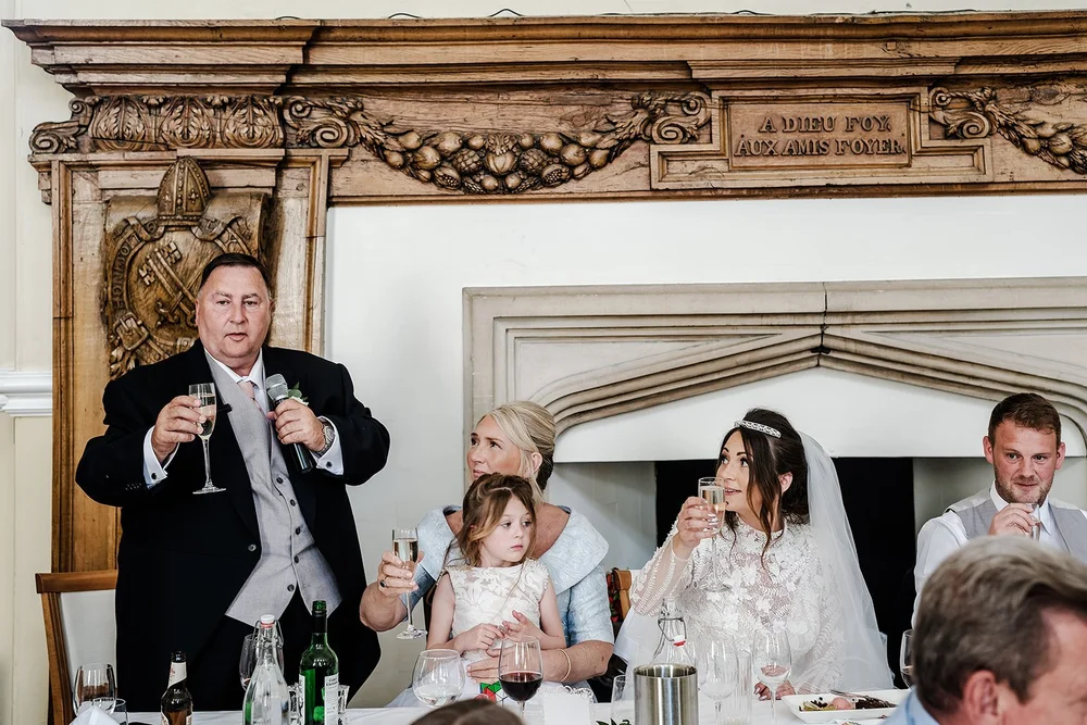 Guests raising a toast during the speeches at Farnham Castle