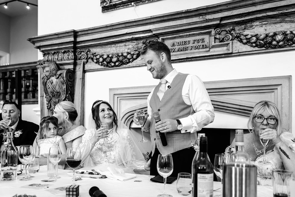 Black and white photograph of a speech being given at the top table