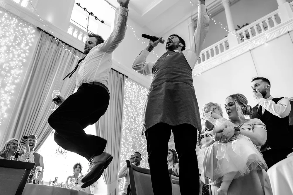 A singing waiter performing during dinner at Farnham Castle