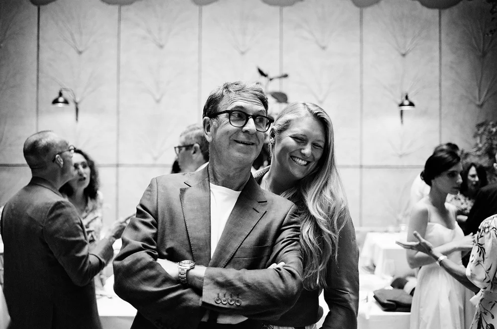 Wedding guests dancing together, shot on 35mm black and white film