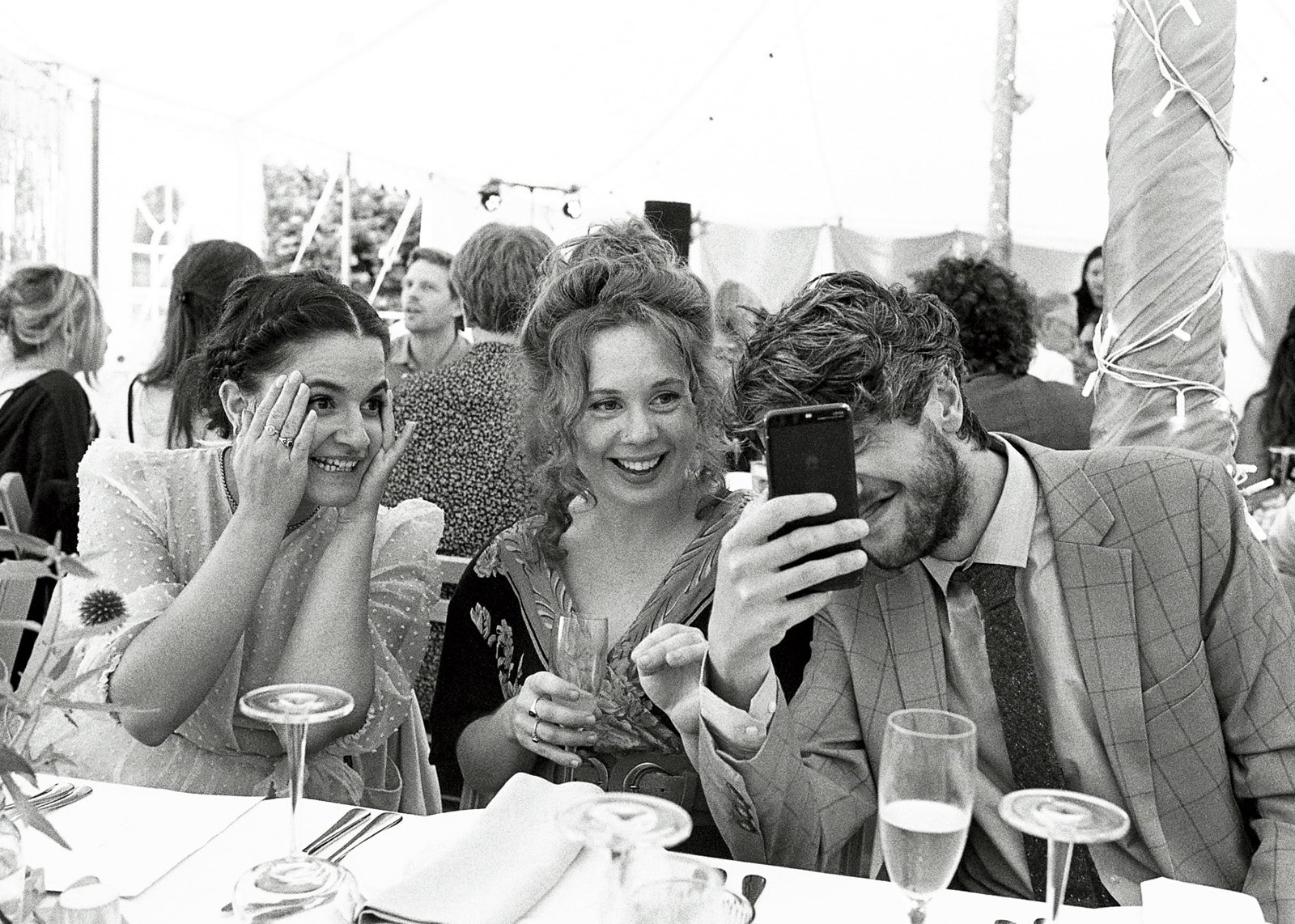Wedding guest candid in black and white on analogue film &mdash; documentary photography with rich tonal range