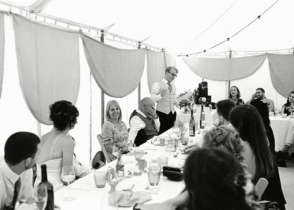Long tables under a marquee canopy, photographed on 35mm film