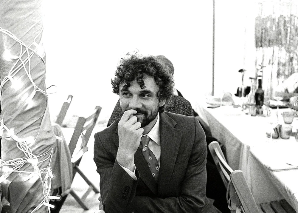 A wedding guest at the table during the speeches, photographed on 35mm film