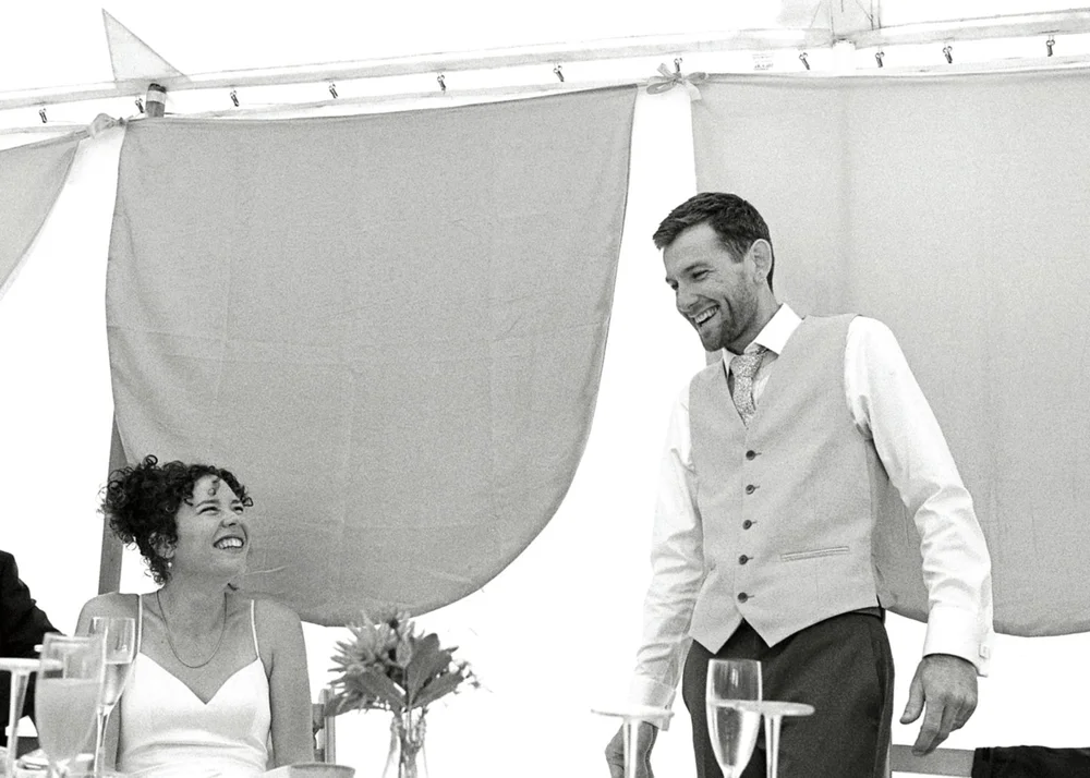 Wedding guests in a marquee, shot on 35mm black and white film