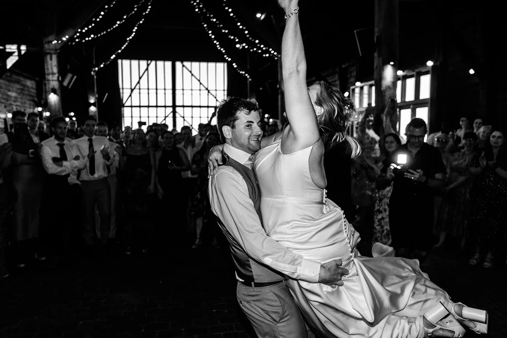 Frankie lifting Rose on the dance floor in the barn at Elmley