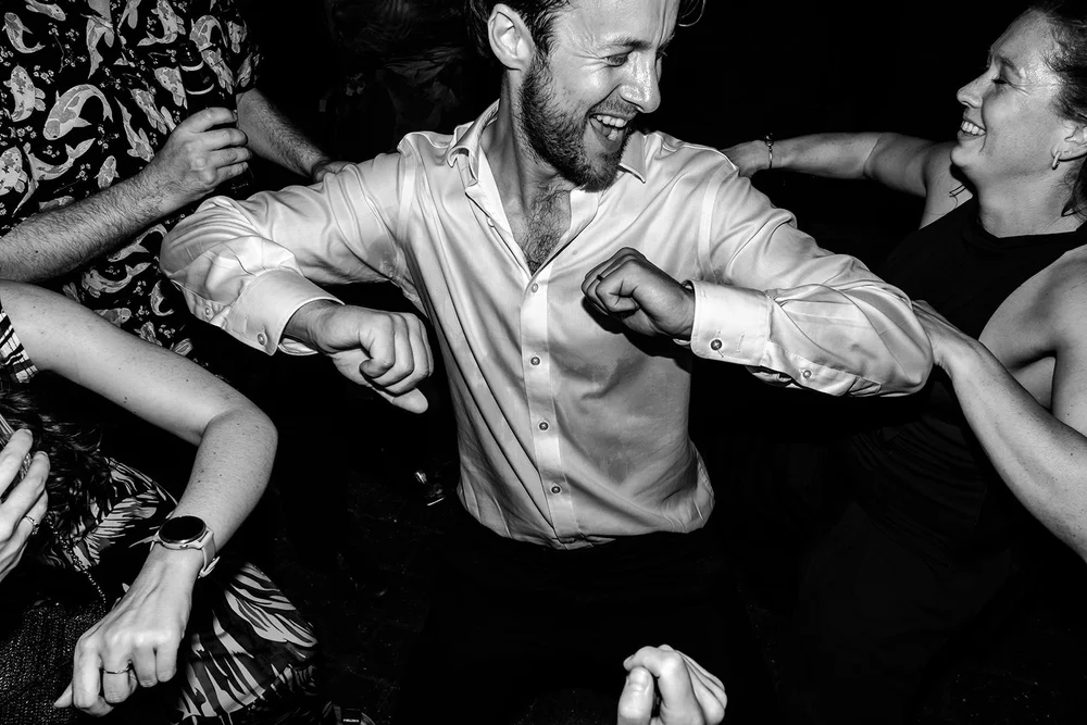 Wedding guests dancing hard in the barn at Elmley