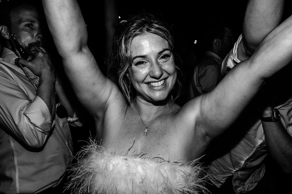 Rose with her arms in the air on the dance floor