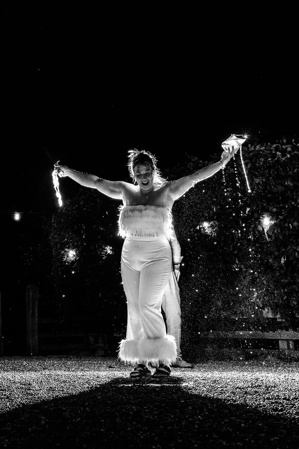 Rose holding sparklers outside the barn at Elmley Nature Reserve at night