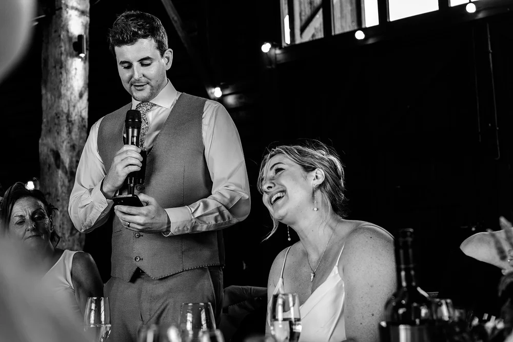 Frankie giving his groom speech while Rose laughs beside him