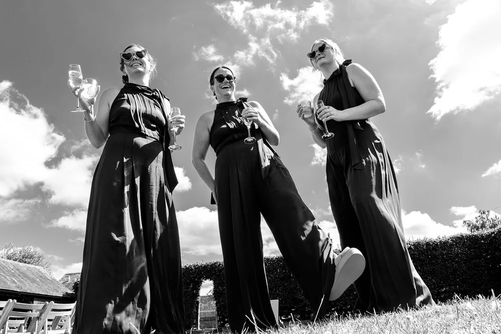 Bridesmaids with drinks in the sunshine at Elmley Nature Reserve