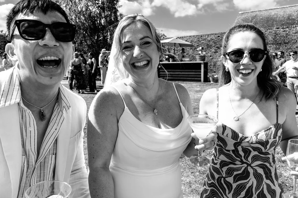 Guests laughing in the sun at the Elmley Nature Reserve drinks reception