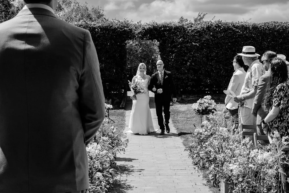 Rose walking up the path towards the outdoor ceremony at Elmley Nature Reserve