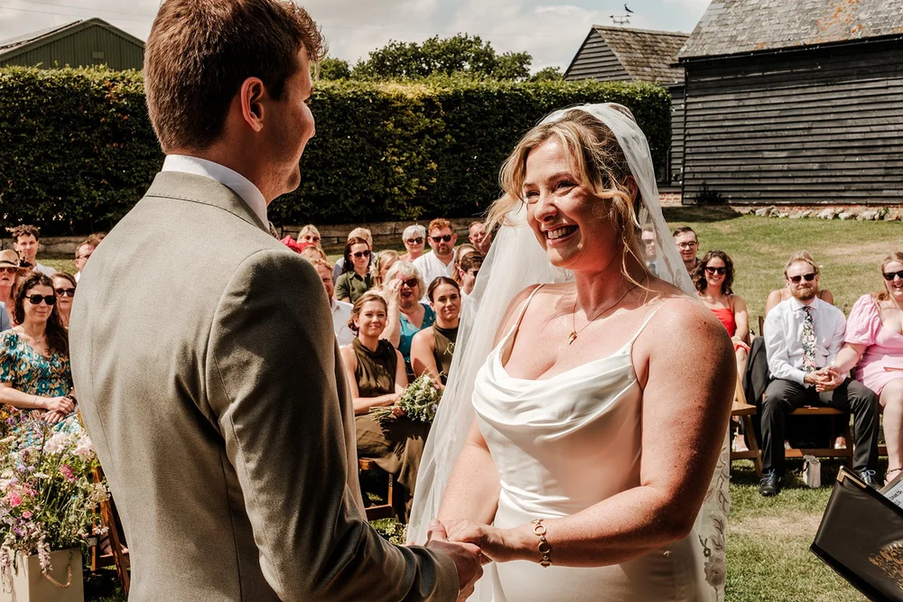 Rose and Frankie facing each other during their outdoor vows
