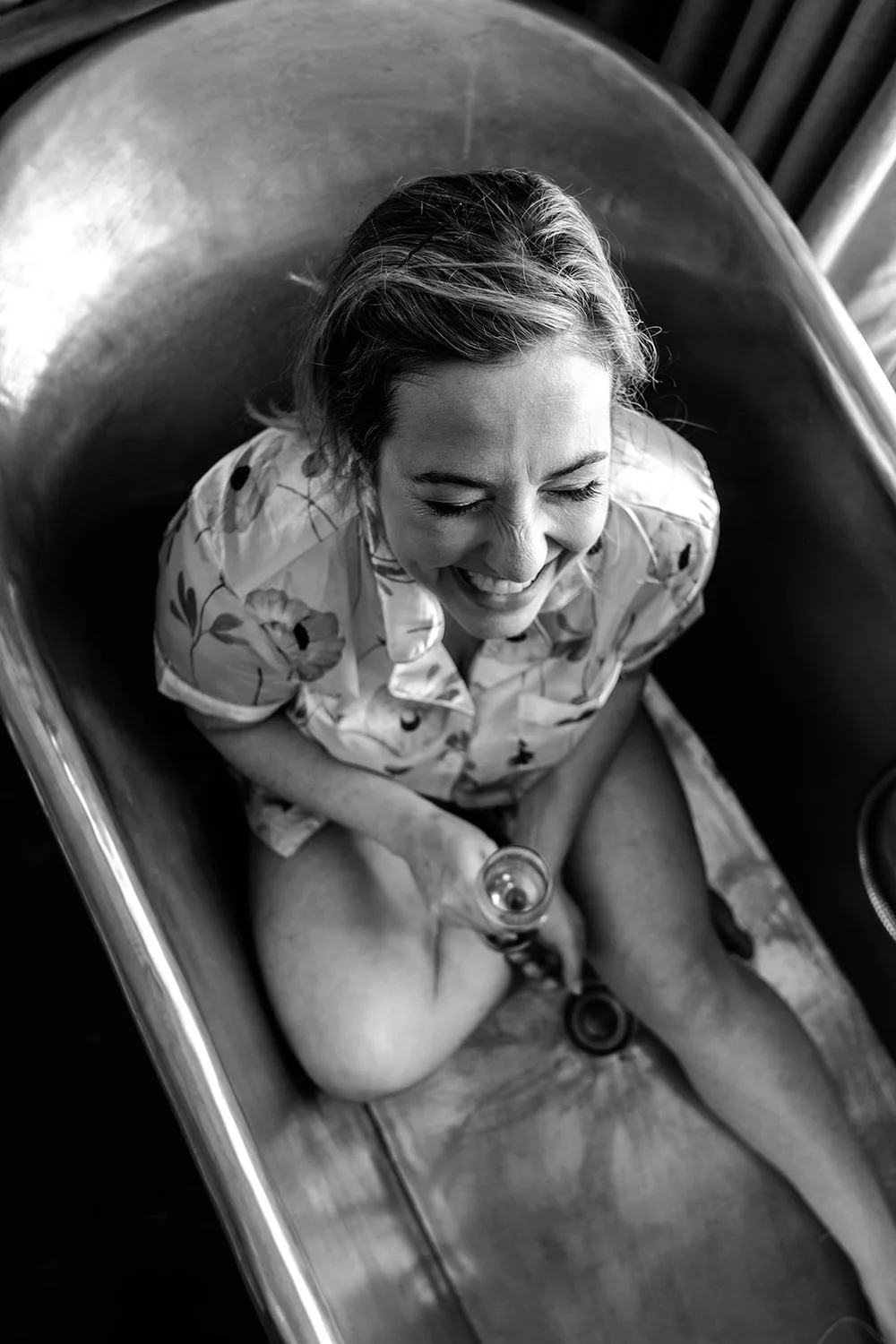 Black and white photograph of Rose in the roll top bath before the wedding