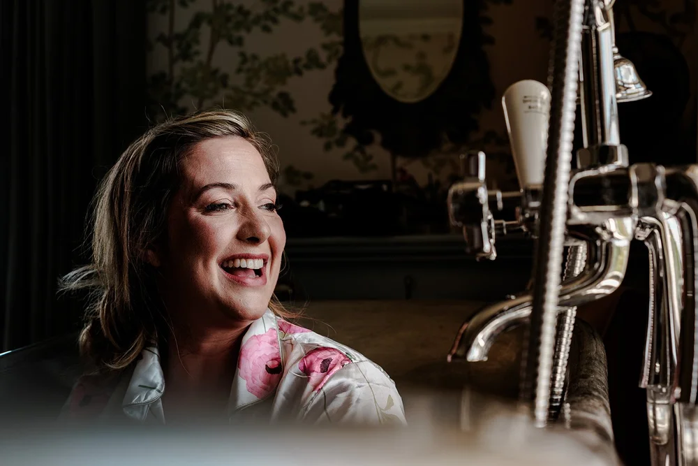 Rose laughing in the bathroom on her wedding morning at Elmley