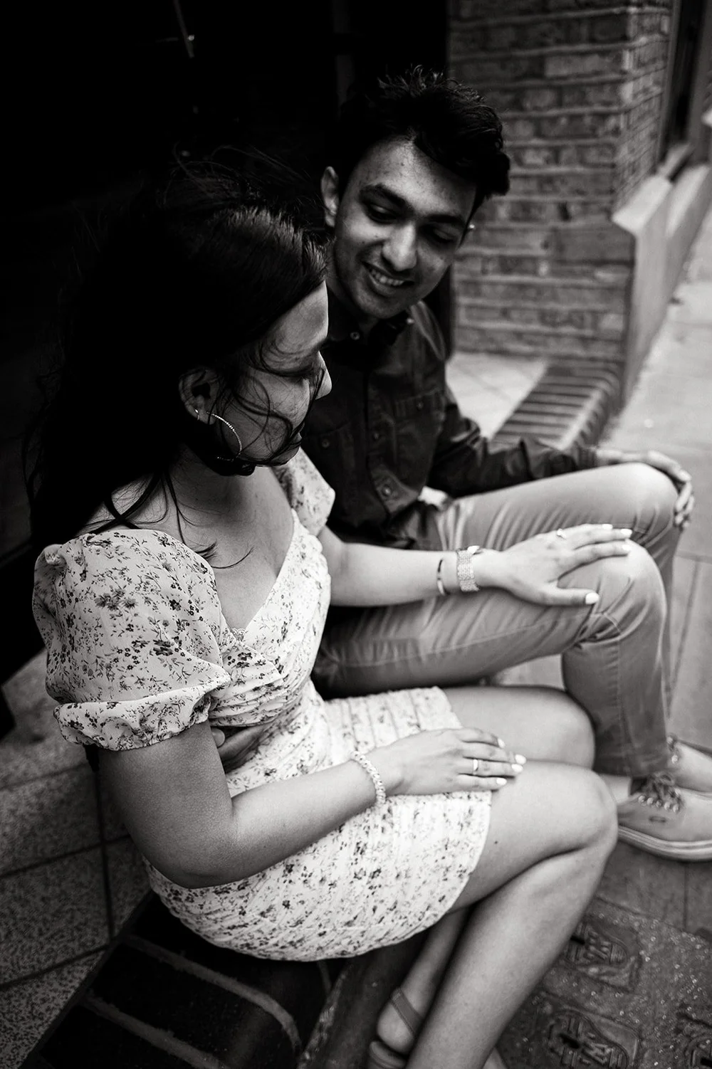Newly engaged couple beside Tower Bridge on the River Thames