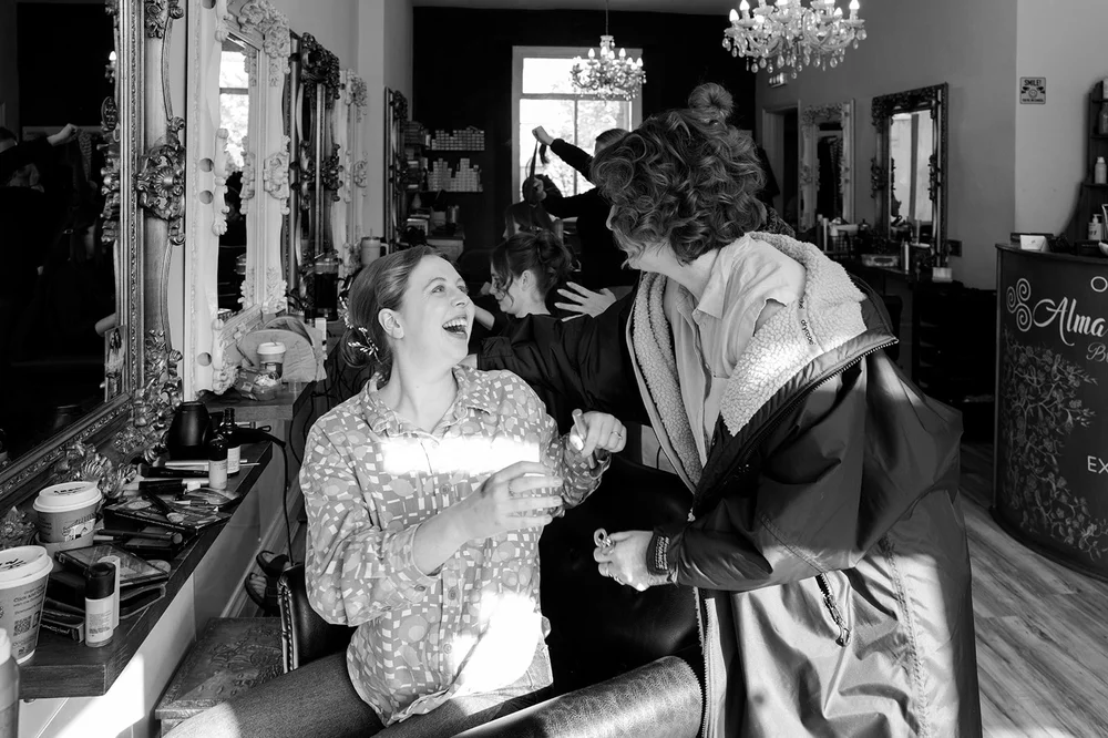 Ffion laughing with a friend on the morning of her Clifton wedding