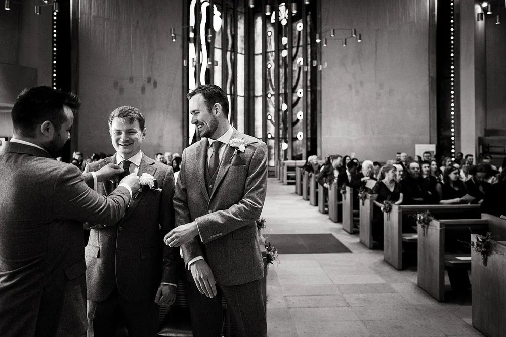 Tom and his best man waiting at the front of All Saints, Clifton