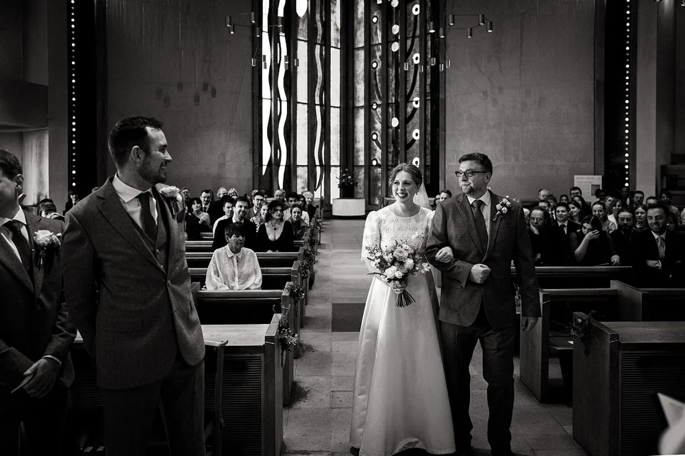 Ffion coming down the aisle with her father at All Saints Church, Clifton