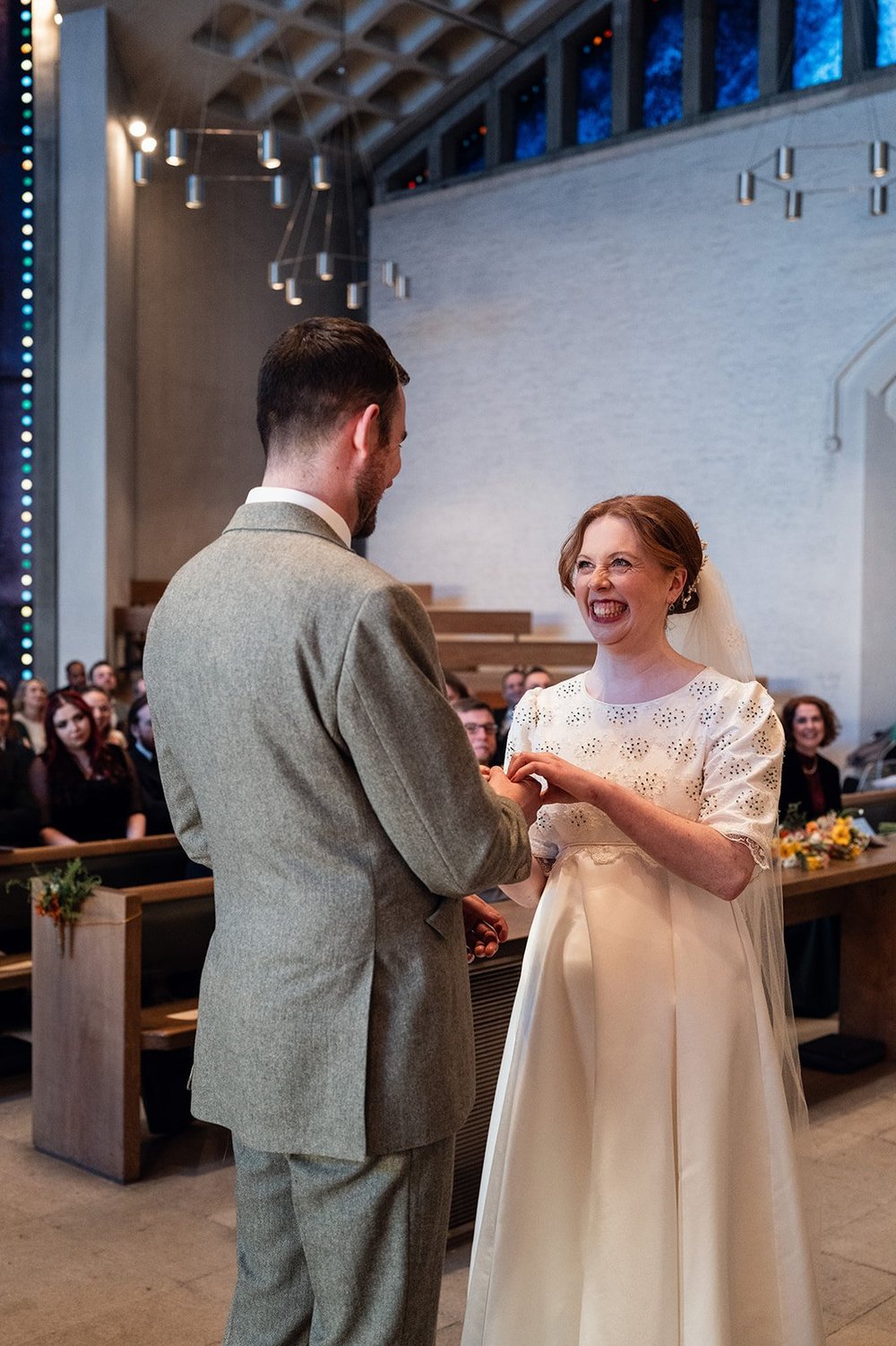 Ffion and Tom exchanging vows at All Saints Church, Clifton, Bristol