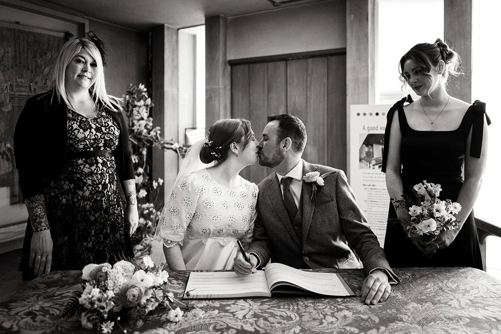 Ffion and Tom kissing after signing the register, Clifton