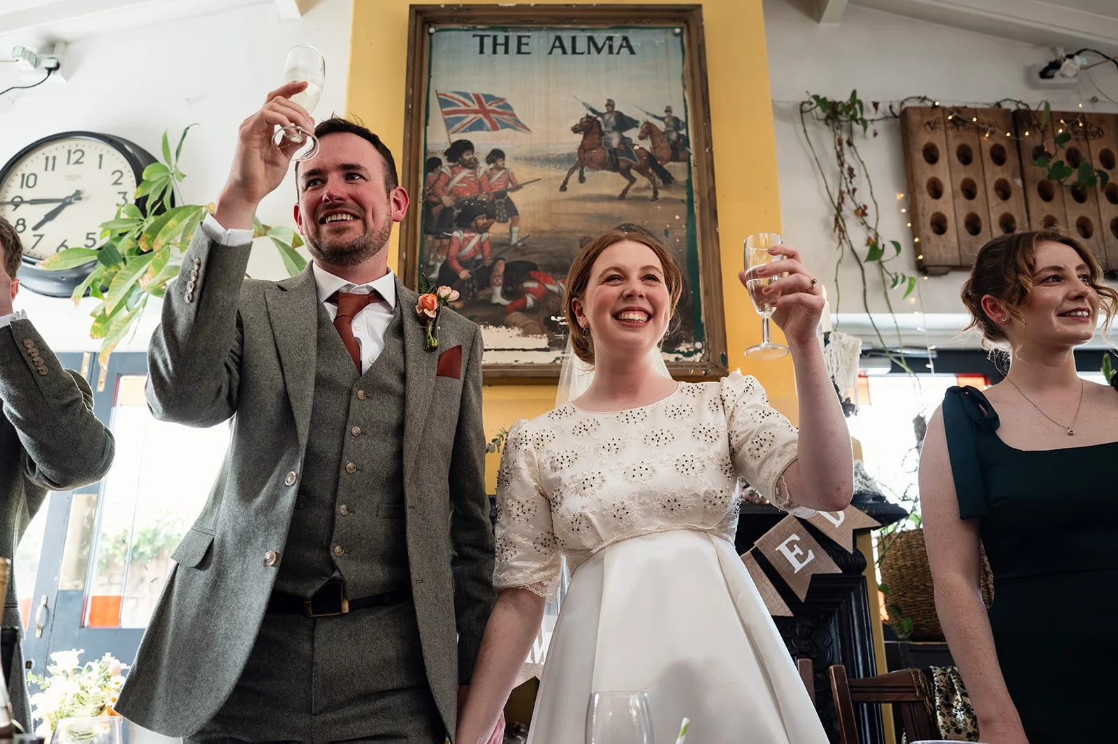 Ffion and Tom cheering during the toast at the Alma Tavern, Bristol