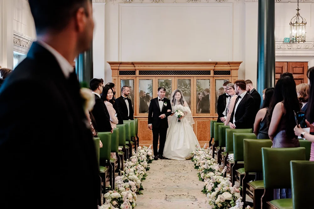 Bride walking down the aisle at her wedding ceremony at The Ned Hotel
