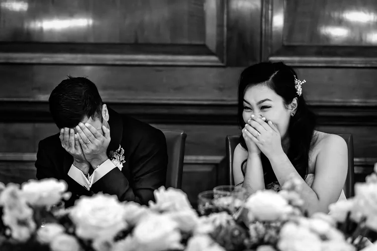 Couple in fits of laughter during the speeches at their Ned Hotel wedding