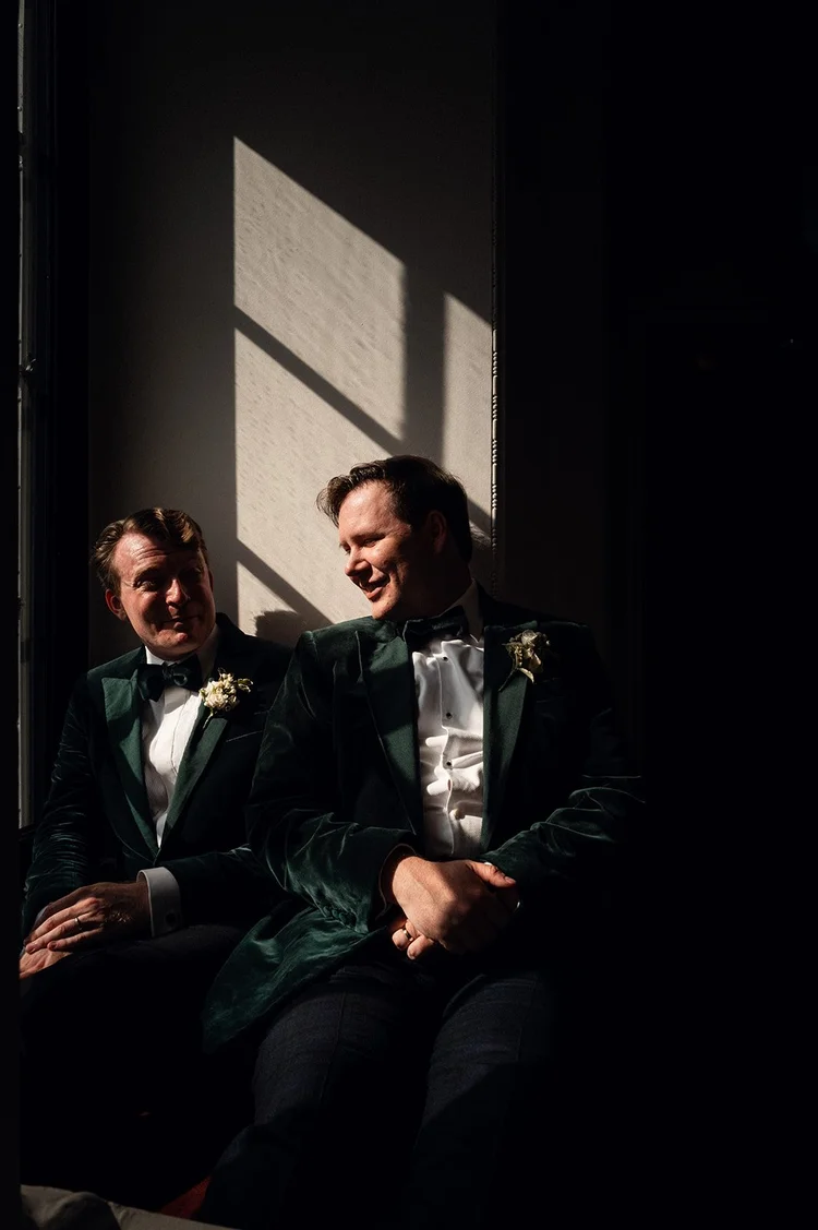 Two grooms photographed in the low evening light at The Ned Hotel