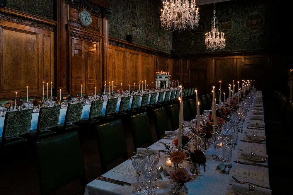 Long candlelit table set for a wedding breakfast in the Tapestry Room at The Ned