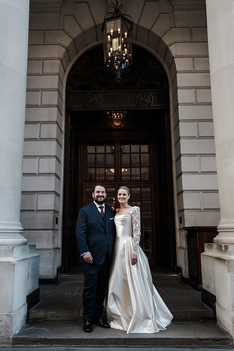 Couple photographed in the arched doorway at the entrance to The Ned