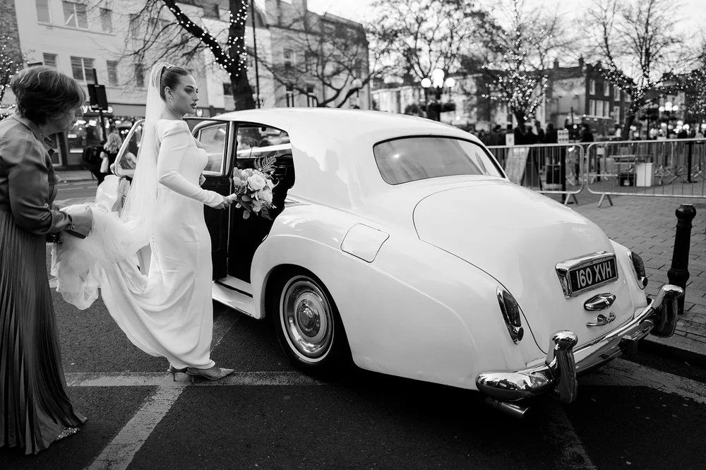 Sophie stepping out of a vintage white Rolls-Royce outside Islington Town Hall on Upper Street