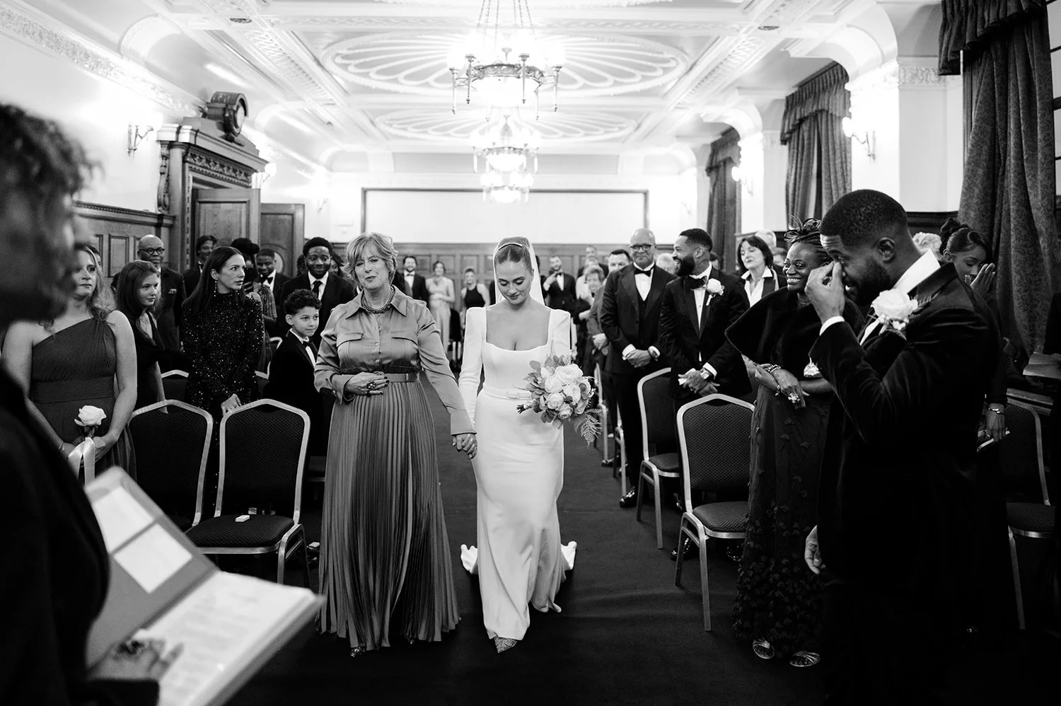 Sophie walking down the aisle in the Council Chamber at Islington Town Hall