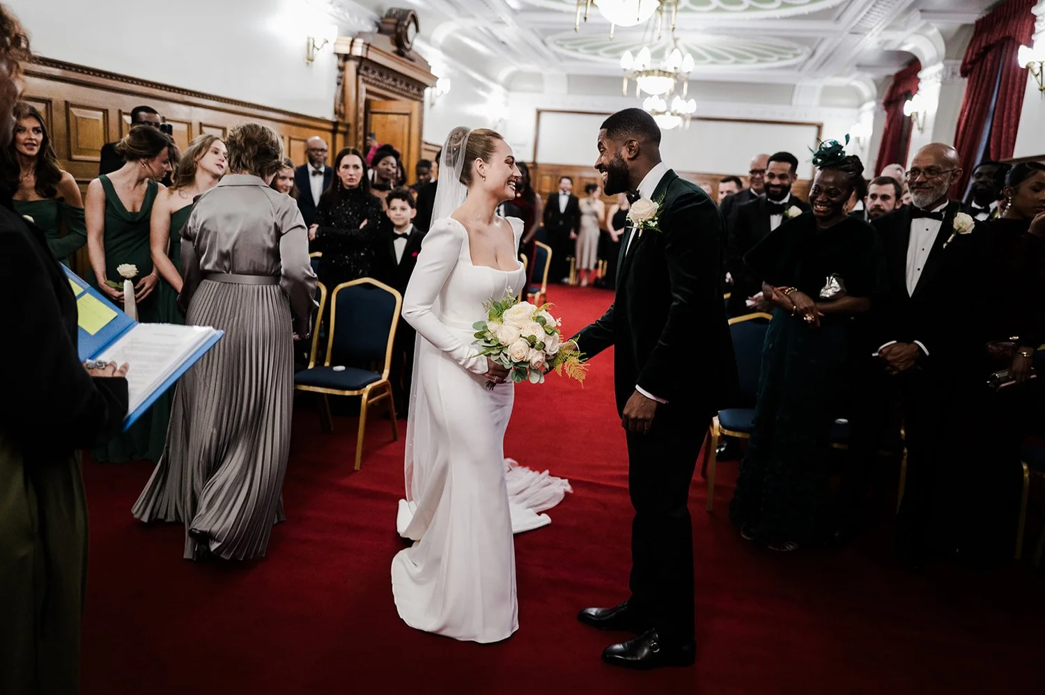 Sophie and Dan standing together at the front of the ceremony room at Islington Town Hall