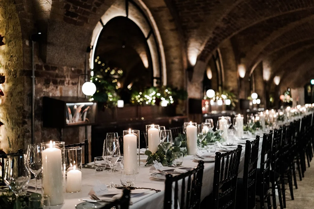 The long candlelit table under the brick vaults at The Libertine by the Royal Exchange