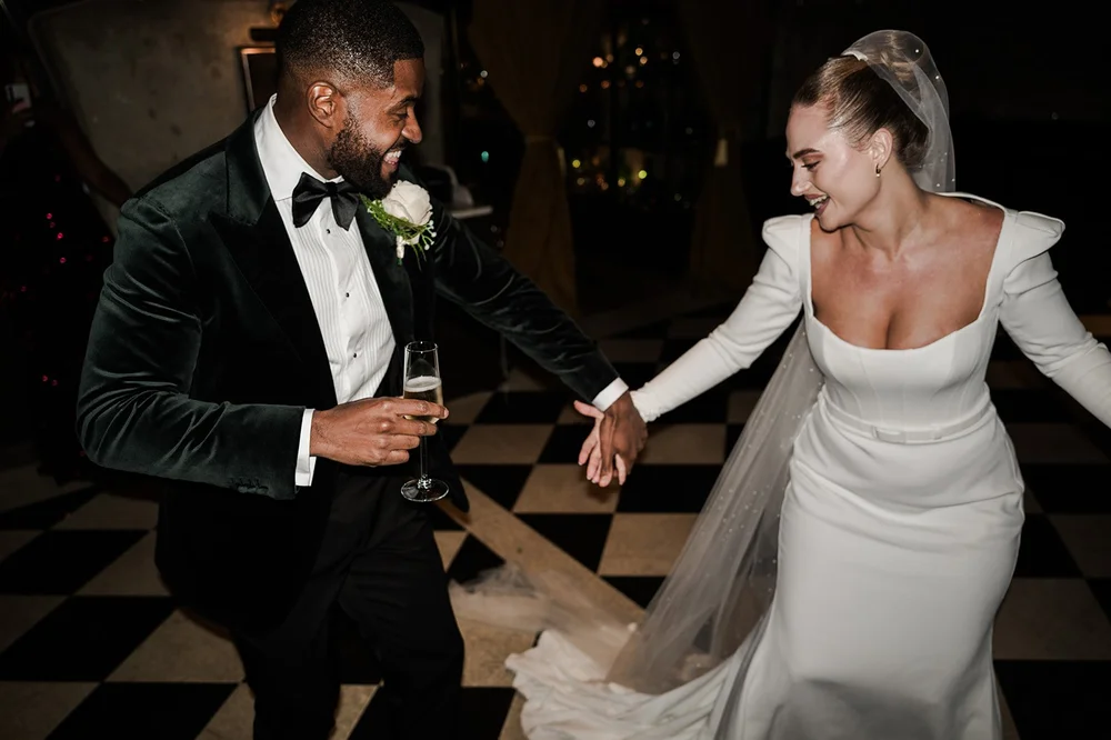 Sophie and Dan with drinks at their wedding reception in the City of London