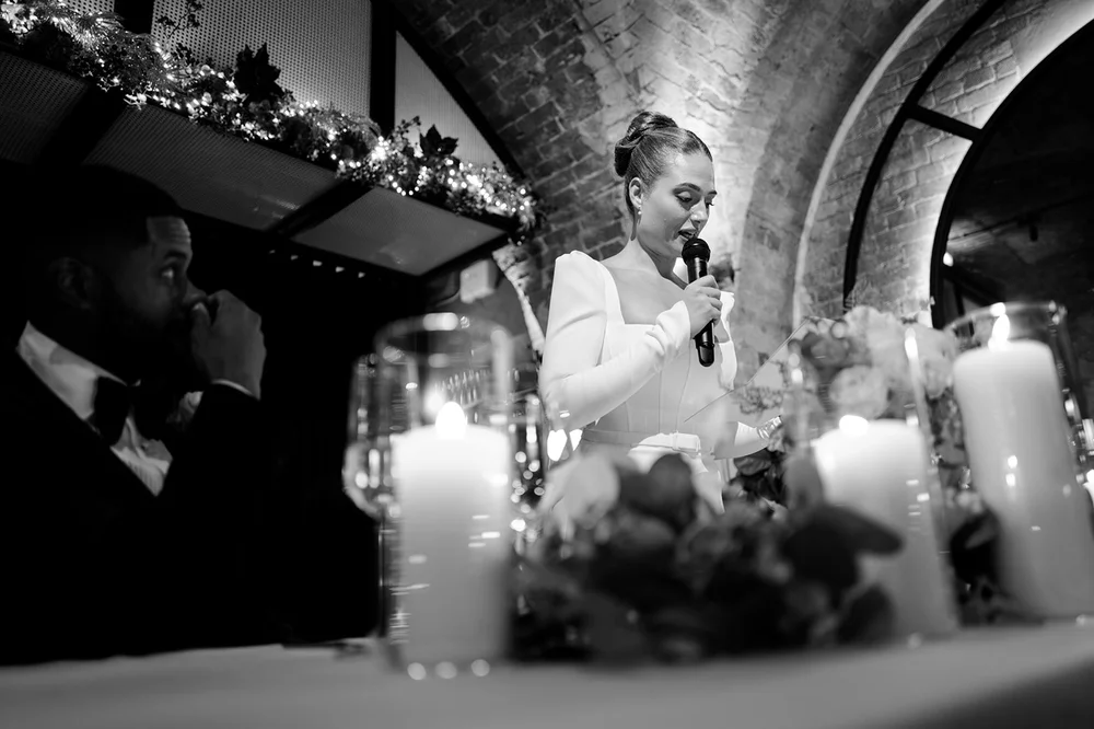 Black and white photograph of Sophie at the candlelit table during dinner
