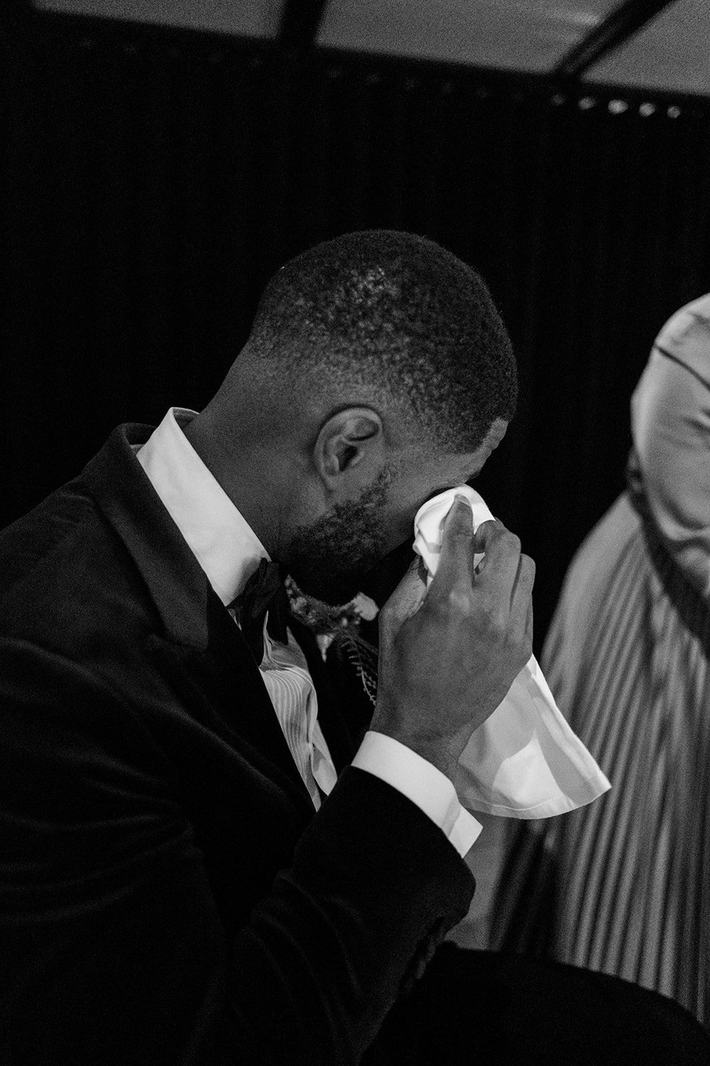 Black and white photograph of Dan during an emotional moment in the speeches