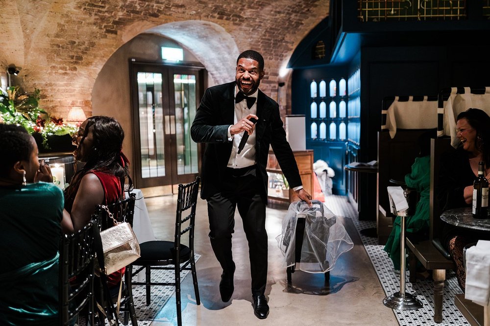 A guest standing to give a speech at the wedding reception in the City of London