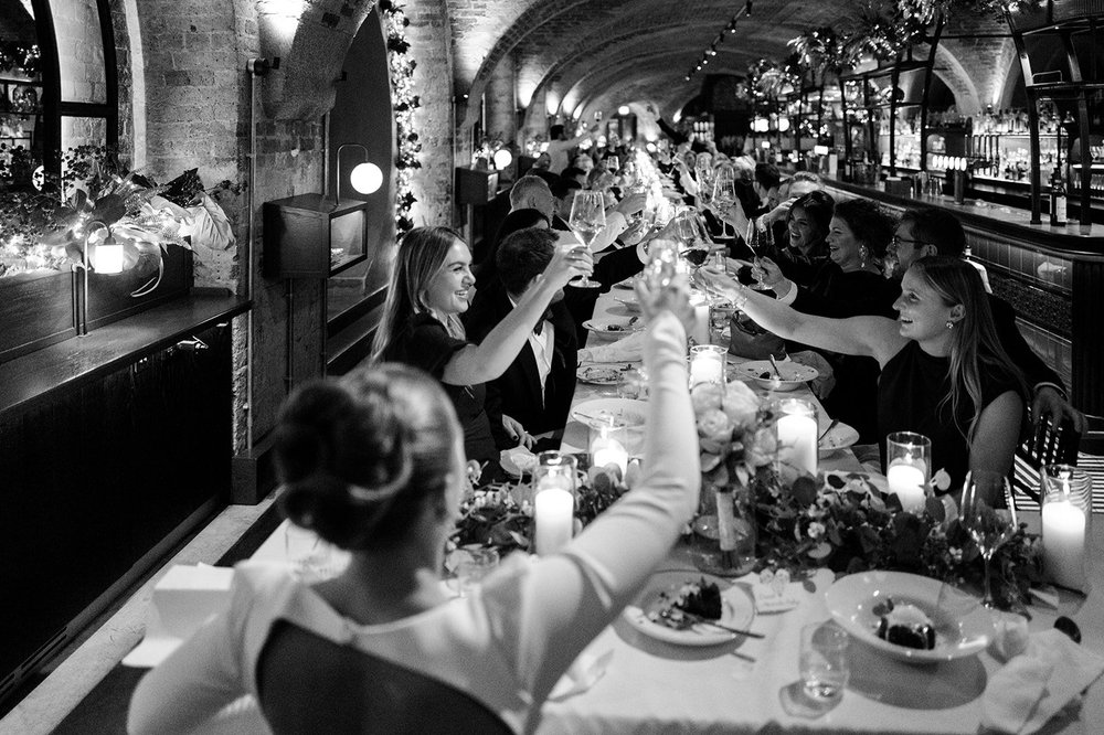 Black and white photograph looking down the wedding table during the speeches