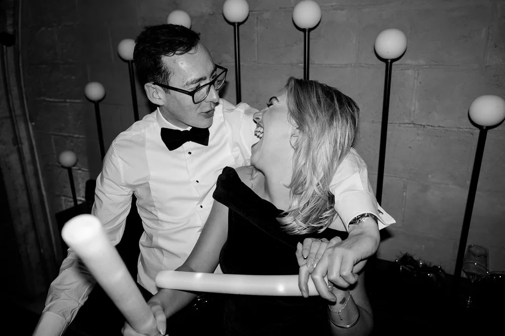 Black and white photograph of guests dancing at the wedding